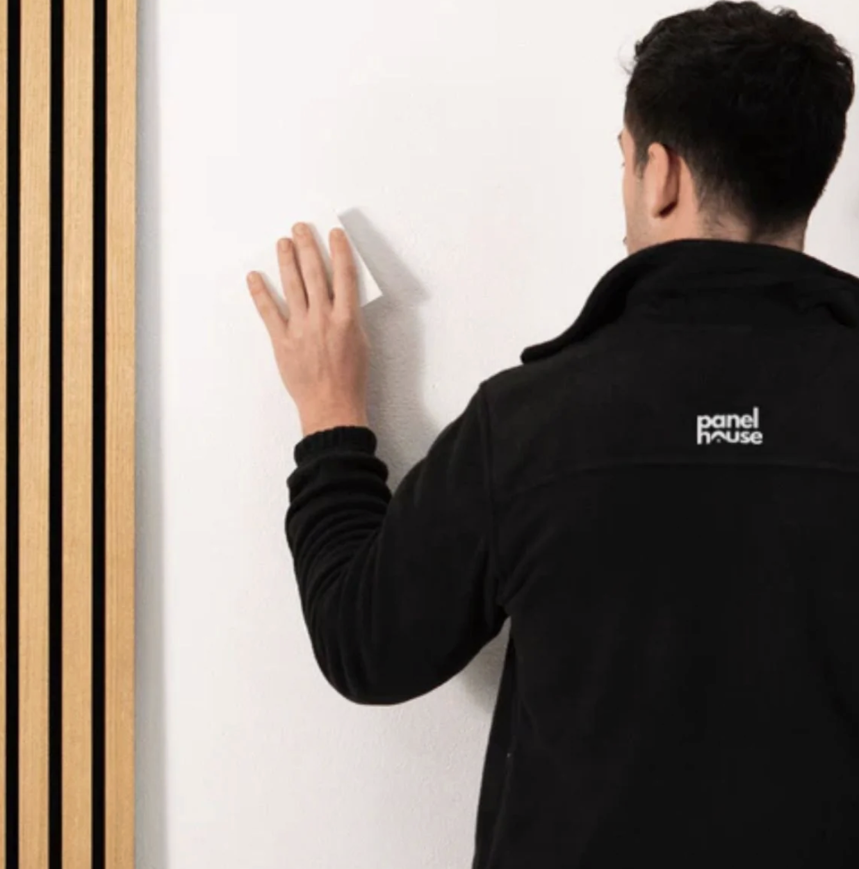 Man installing wood panel