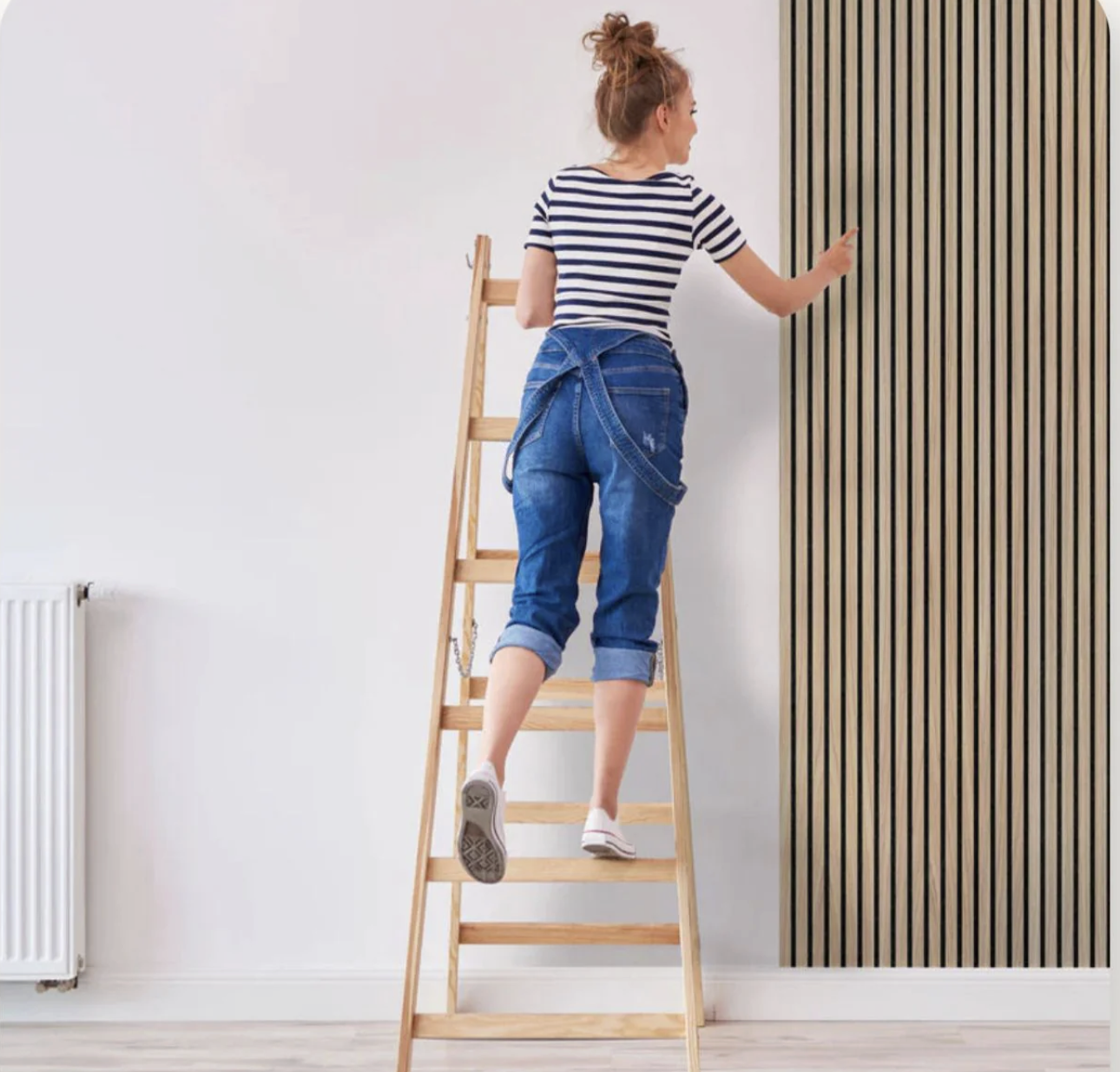 Woman on ladder installing panel